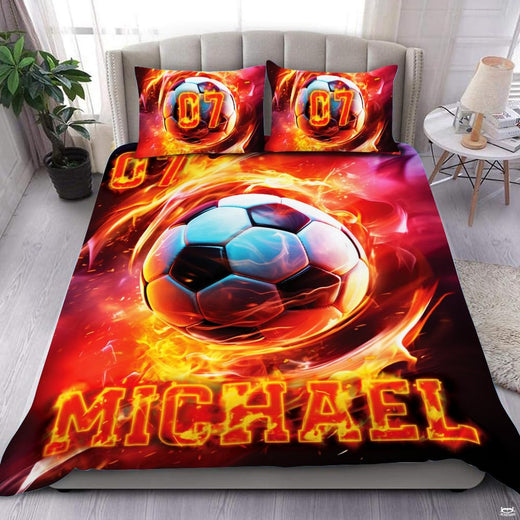 Fire and ice soccer ball flame athletic bedding set displayed neatly on a bed in a sporty room