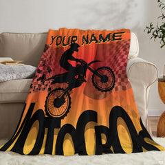 Extreme sports dirt bike throw blanket folded on wooden bench