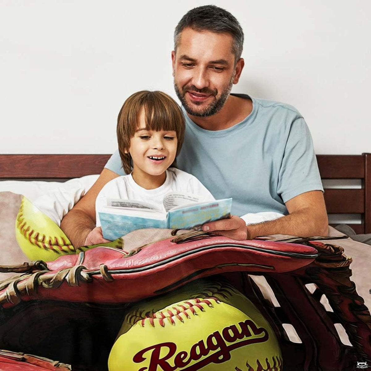 Red softball mitt sports blanket folded neatly in bedroom space