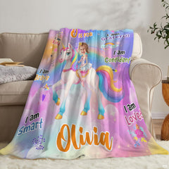 Rainbow unicorn fairytale blanket draped over domestic armchair
