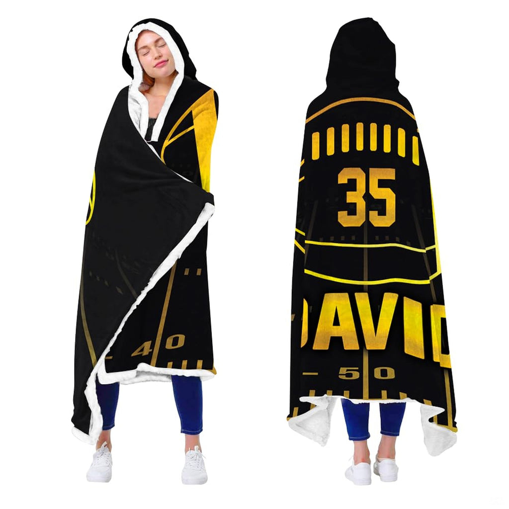 Close up of black and gold football throw blanket highlighting luminous gold athletic typography