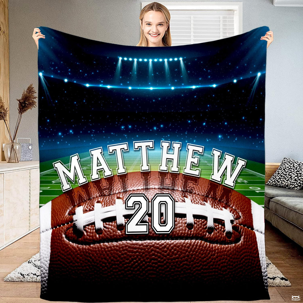 Football field night stadium lights throw blanket displaying a textured football on the field under arena lights
