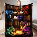 Fantasy bookshelf blanket featuring five colorful dragons reading glowing magical books in a library.