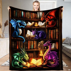 Fantasy bookshelf blanket featuring five colorful dragons reading glowing magical books in a library.
