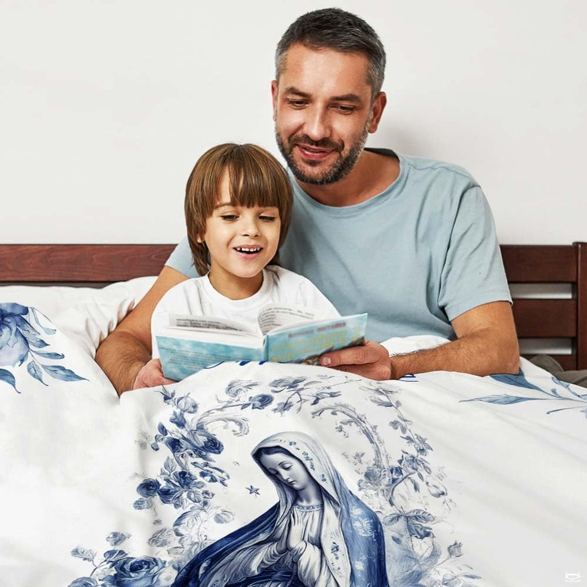 Bed mockup displaying top section of Blessed Mother blue floral artwork with reading family.
