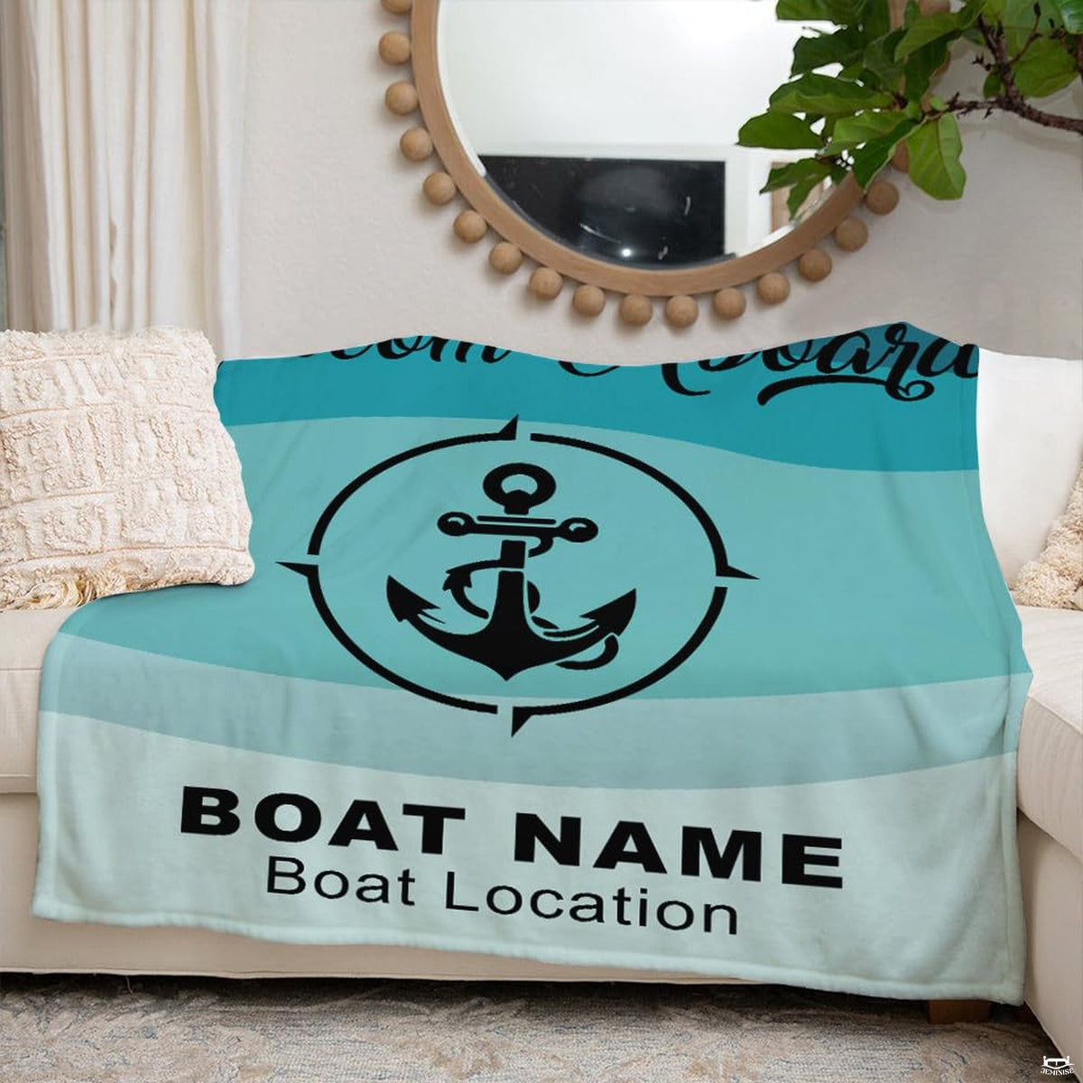Coastal anchor blanket displayed across beige couch in bright room beside round mirror