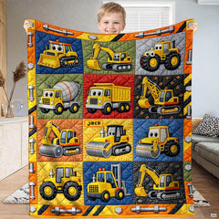 Construction vehicle bedding set displaying cartoon dump trucks, bulldozers, and excavators in a colorful patchwork grid.