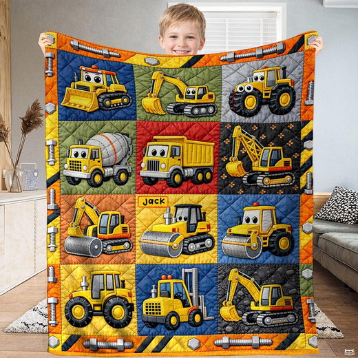 Construction vehicle bedding set displaying cartoon dump trucks, bulldozers, and excavators in a colorful patchwork grid.