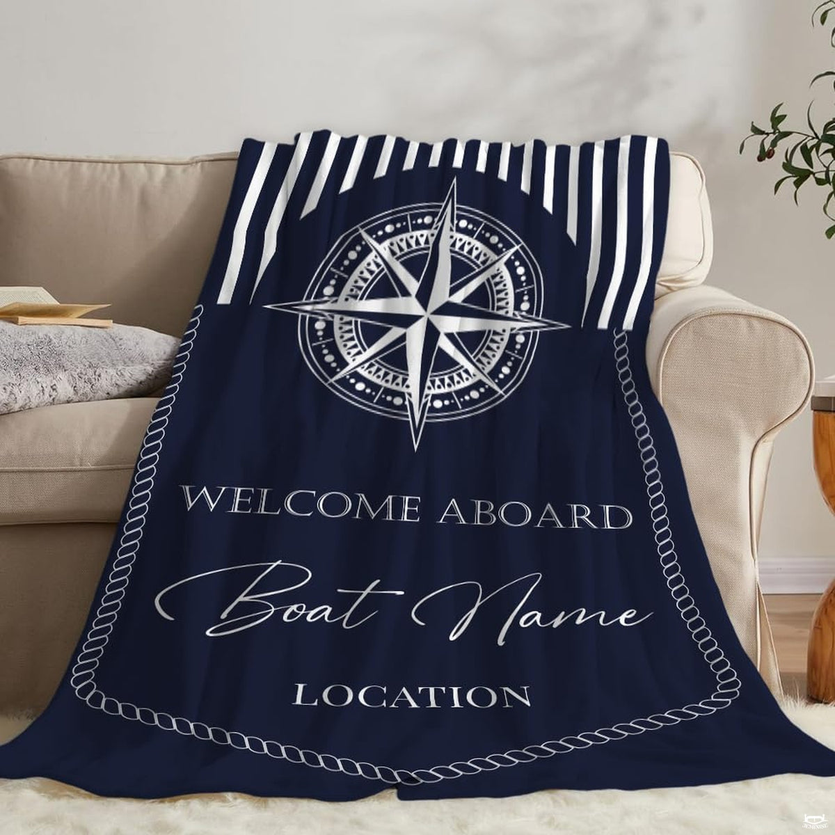 Close-up view of the detailed eight-pointed compass rose dial design on navy coastal bedding.