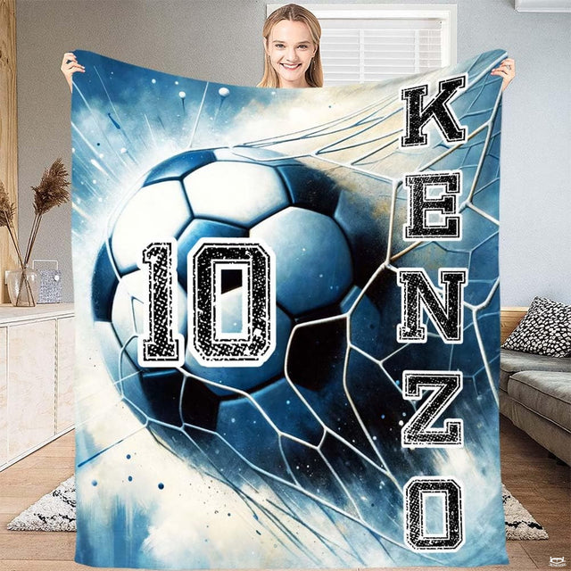 Dynamic soccer ball hitting a goal net with cool blue splash artwork and varsity lettering.