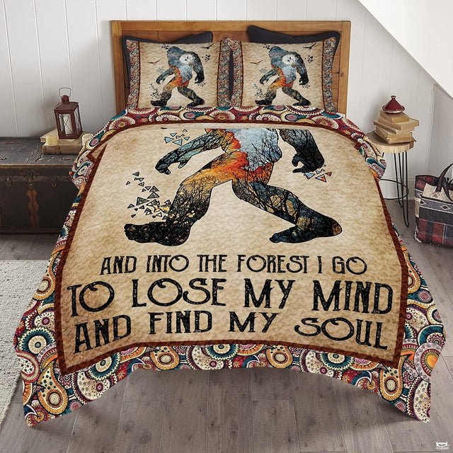 Into the forest Bigfoot bedding set featuring an iconic Sasquatch silhouette and poetic quote lettering on a bed