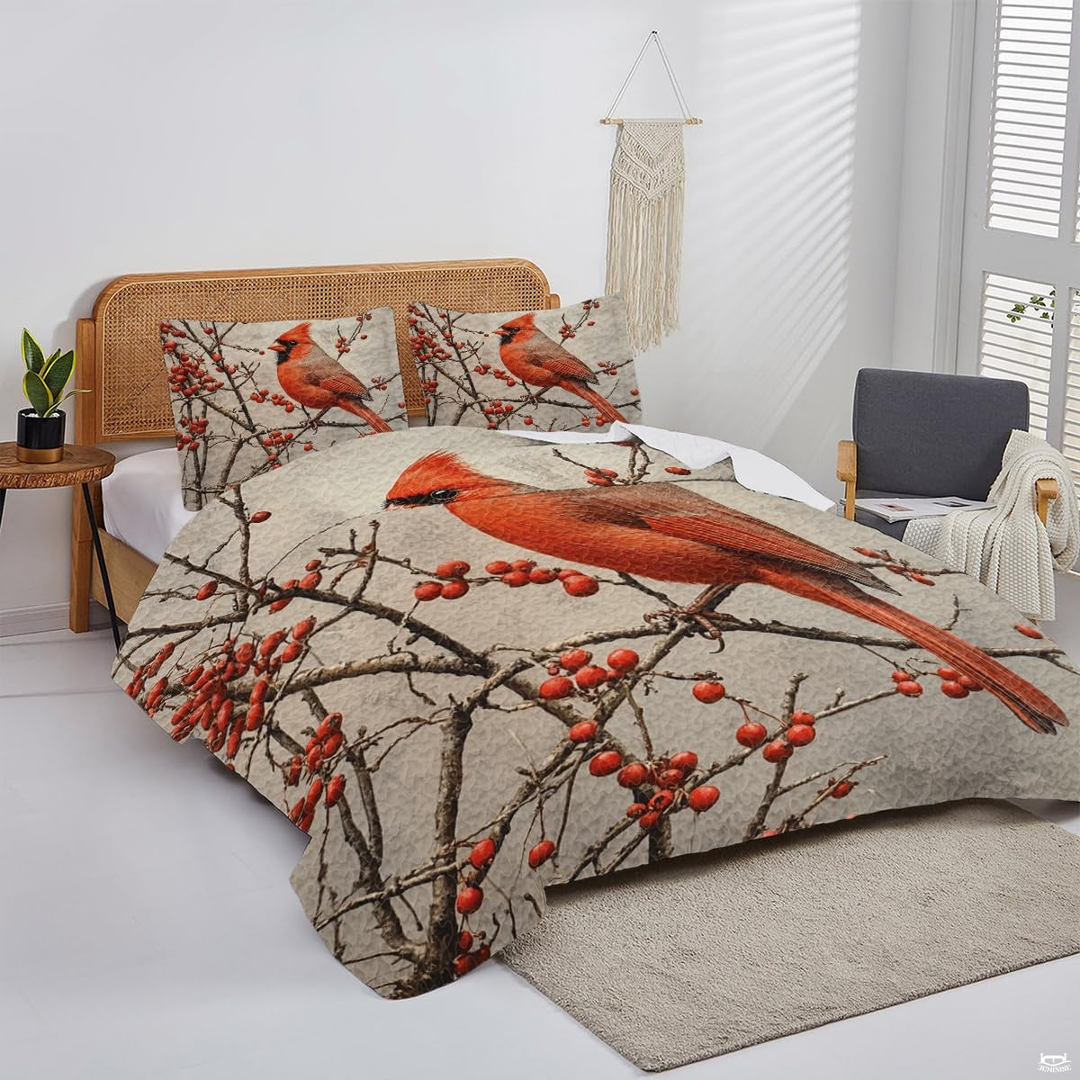 Overhead view of little bird bedding set displaying cardinal motifs and textured parchment tones.
