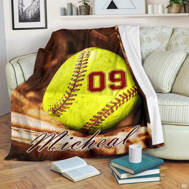 Fastpitch softball fielding mitt graphic blanket draped across living room sofa
