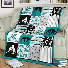 Teal wrestling patchwork blanket draped over a living room couch beside a stack of books.