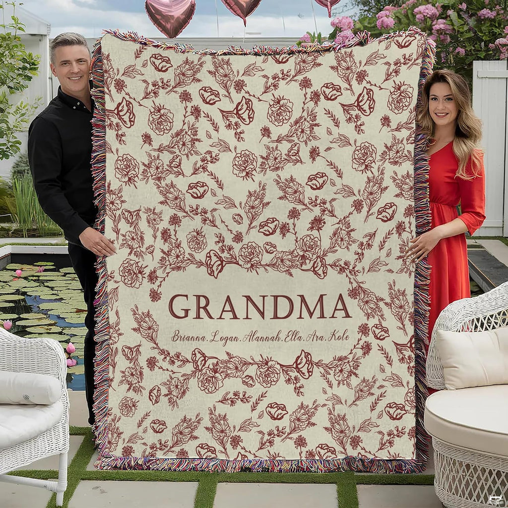 Burgundy floral toile pattern with central wreath and woven fringe edge on Blanket.