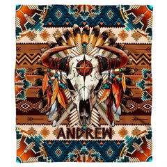 Close-up view of bull skull horns, hanging feathers, turquoise beads, and star emblem.