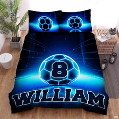 Midnight navy and cobalt soccer sports bedding featuring a soccer ball graphic with electric blue arcs on a bed