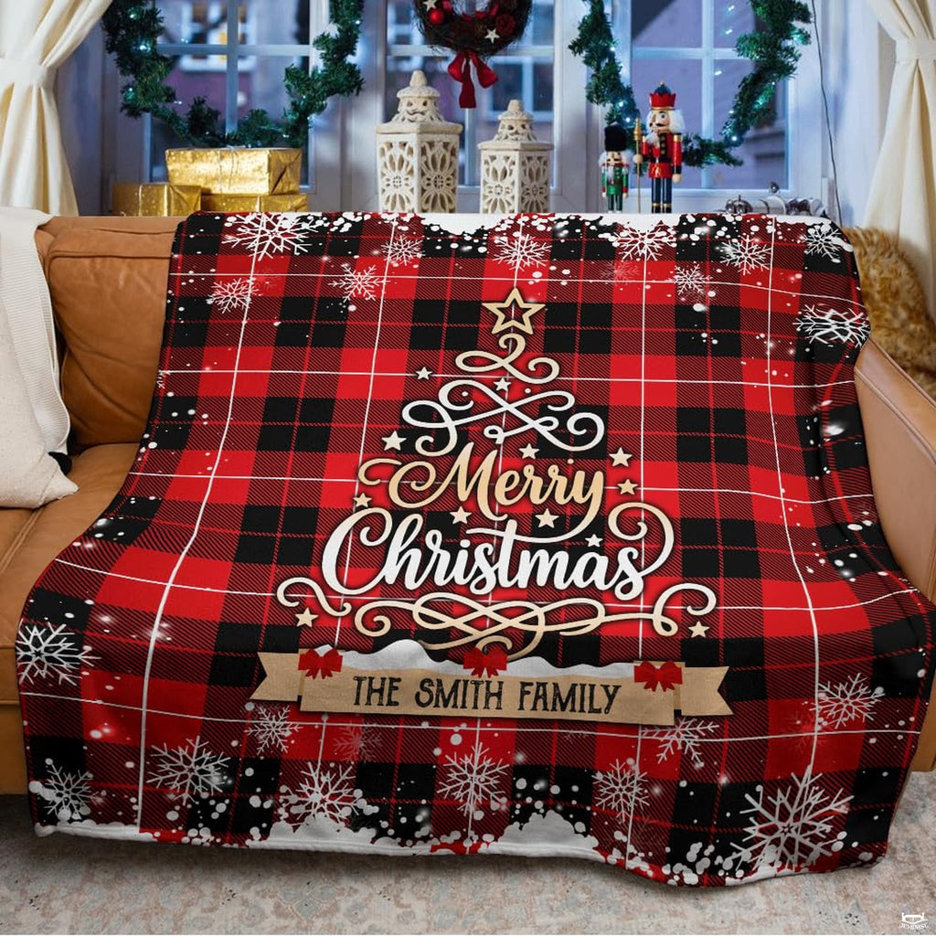 Rustic buffalo plaid Christmas graphic blanket styled across bed