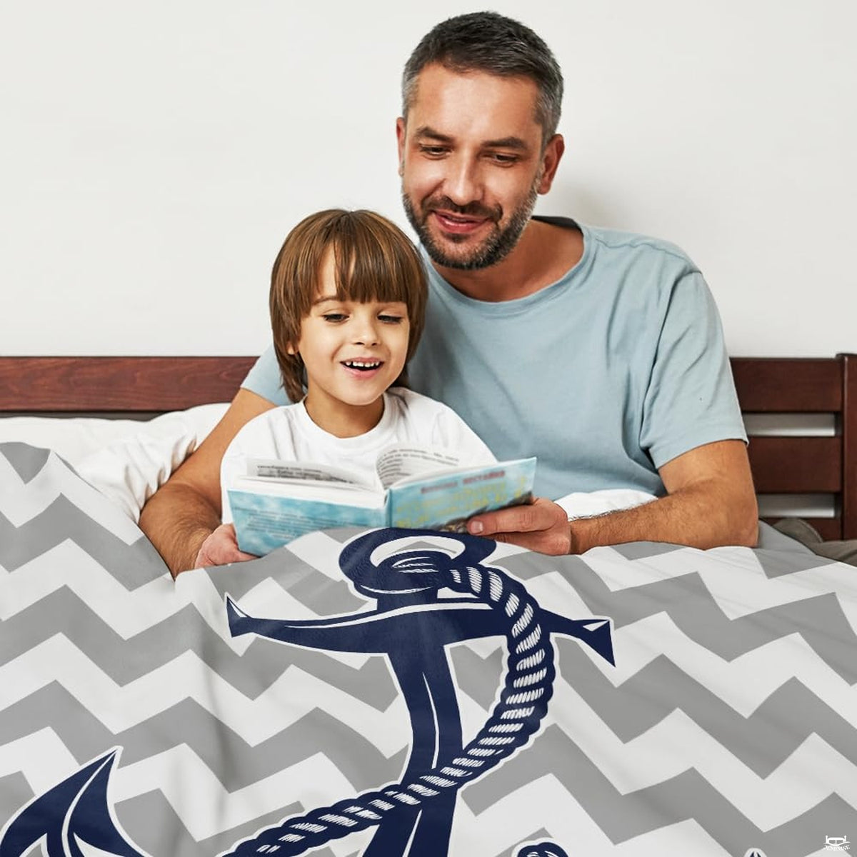Close-up perspective of the sharp chevron zigzag print and central ocean anchor illustration on bedding decor.