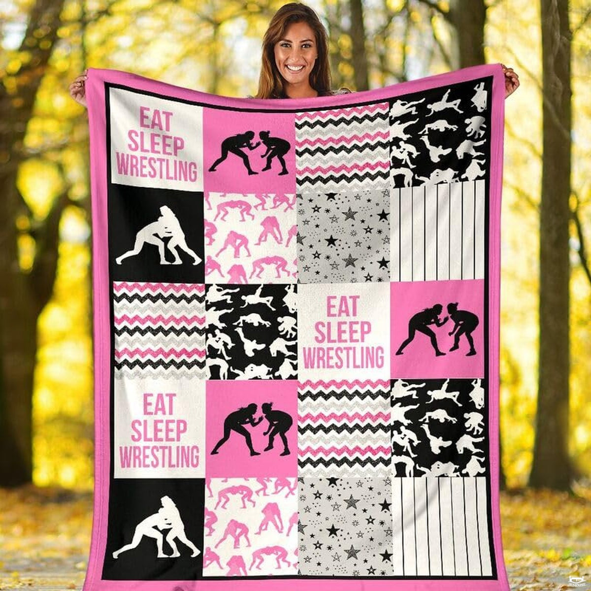 Girls wrestling sports throw blanket styled across a bed in a vibrant bedroom setting.