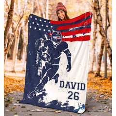 Folded athletic blanket highlighting distressed red banner and navy silhouette