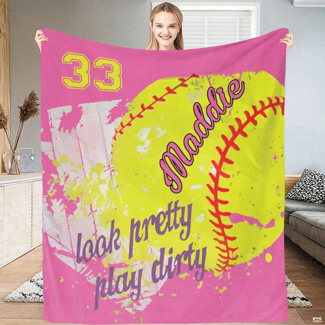Close up macro view of pink softball throw blanket highlighting fabric texture and sharp pink and yellow print