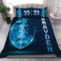 Electric teal football sports bedding featuring textured football graphic and yard lines on a bed