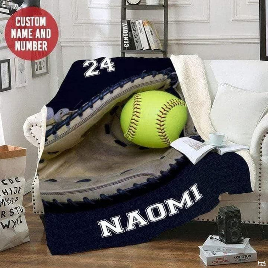 Navy softball mitt artwork styled across a white armchair in a reading room corner.