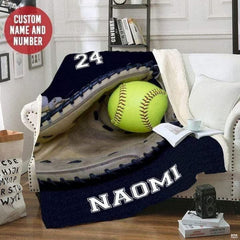 Navy softball mitt artwork styled across a white armchair in a reading room corner.