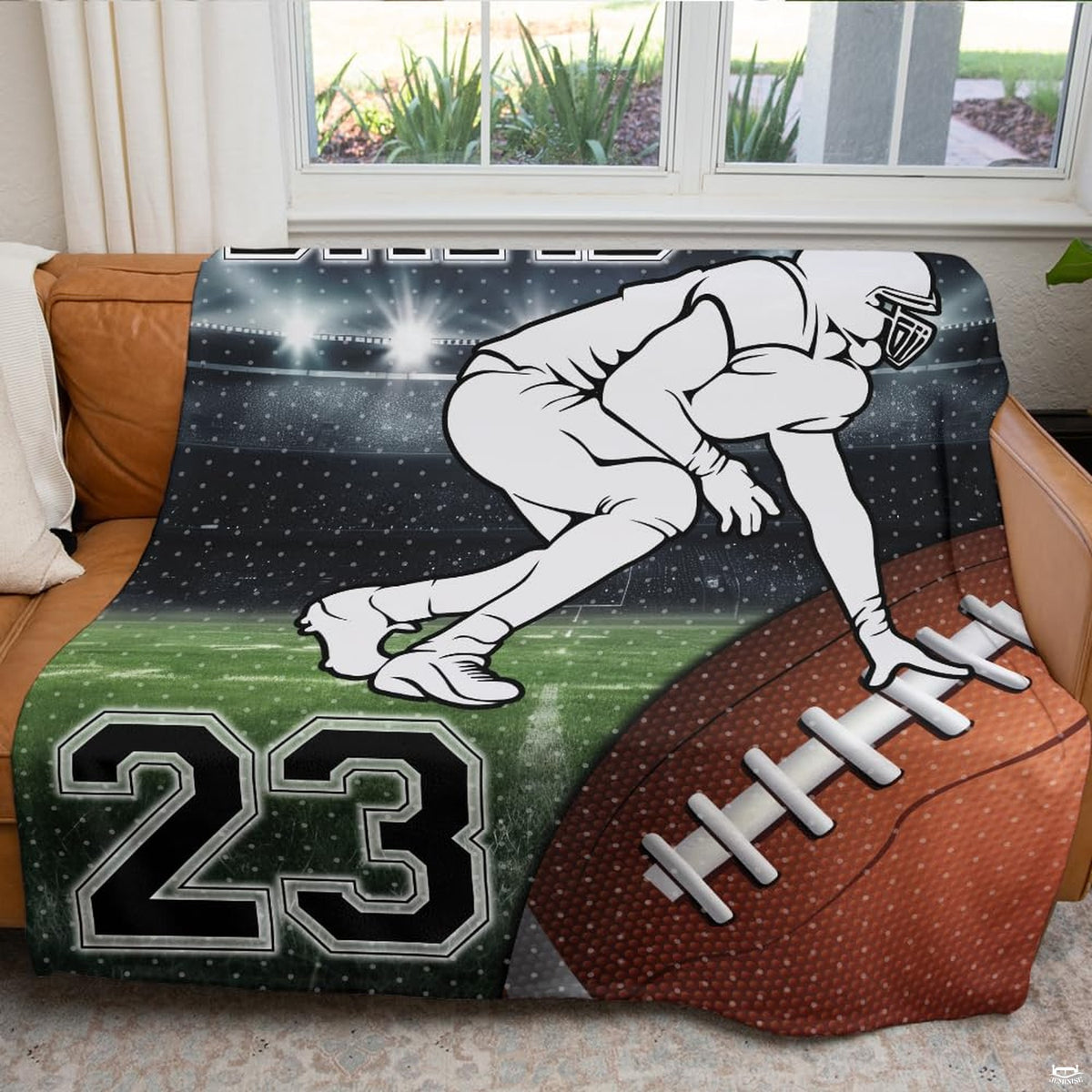 Atmospheric game day fan cave couch setting featuring football lineman stadium graphic throw blanket