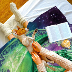 Emerald Celtic dragon throw blanket styled in a cozy lifestyle bed setting