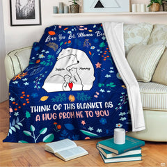 Full spread presentation of polar bear family throw blanket with vibrant wildflower details