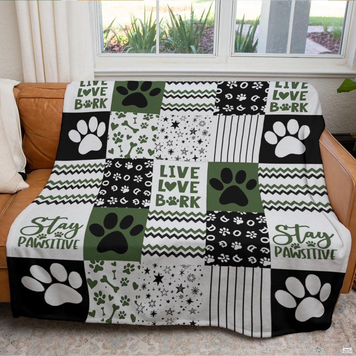 Dog paw bedding displayed in a modern bedroom setting showing geometric chevron zig-zags and olive green accents.