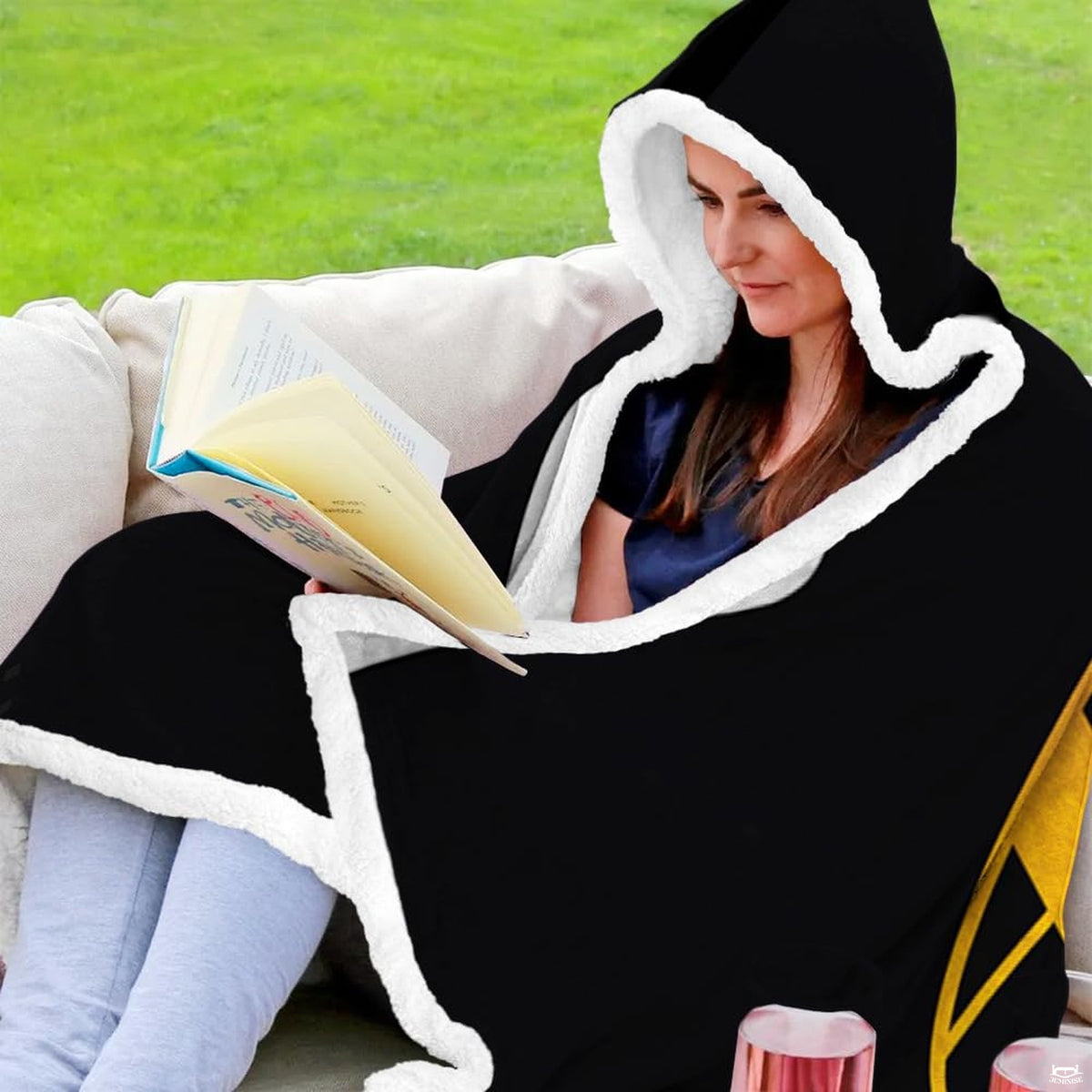 Folded black and gold football throw blanket revealing golden yard markers and black backdrop