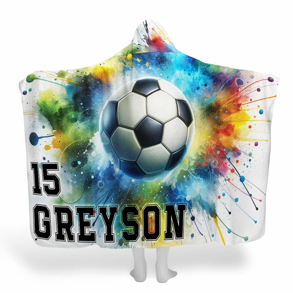 Display showing soccer ball blanket featuring explosive rainbow watercolor splatter artwork