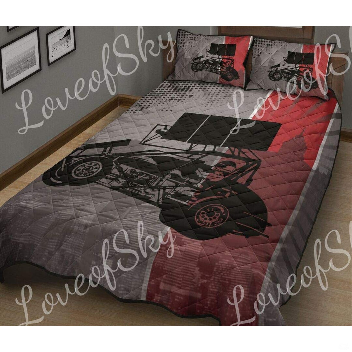 Close-up perspective of racing bedding highlighting red and grey sprint car artwork and textured track smoke