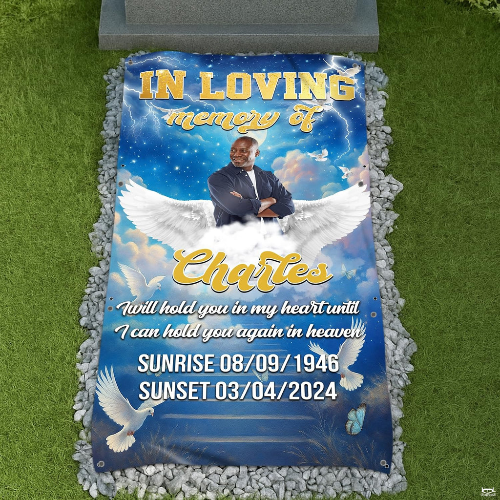 Celestial blue angel wings memorial tribute blanket displayed at graveside with pebbles