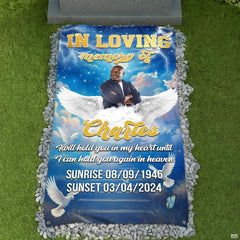 Celestial blue angel wings memorial tribute blanket displayed at graveside with pebbles