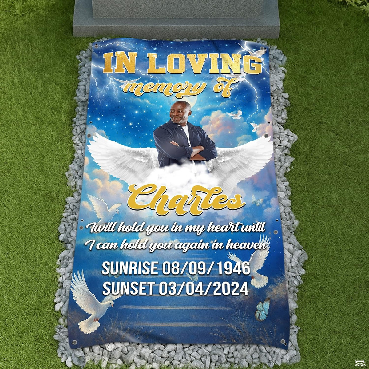 Celestial blue angel wings memorial tribute blanket displayed at graveside with pebbles
