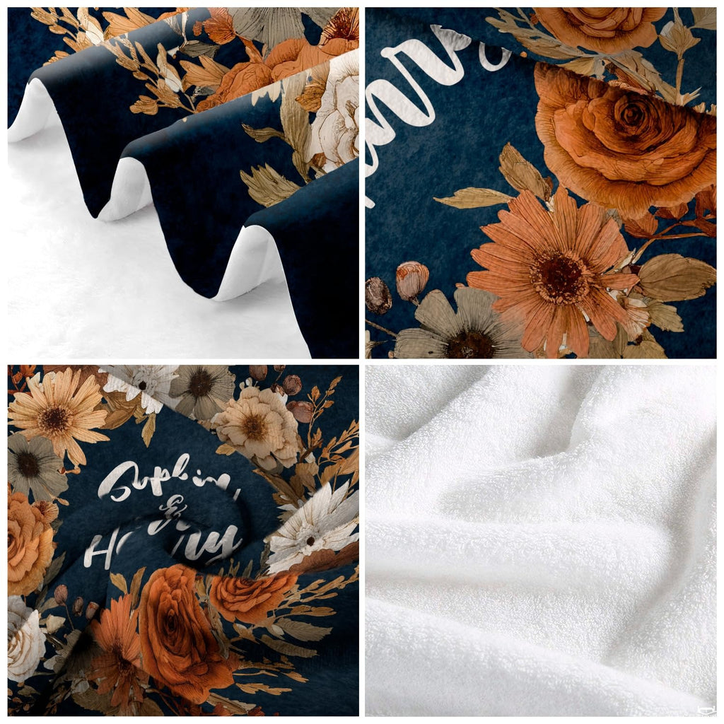 Angle perspective of autumn floral wreath throw blanket styled across contemporary living room sofa
