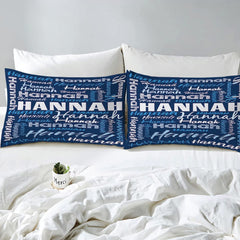 Overhead view of blue typography bedding spread across a contemporary bedroom bed
