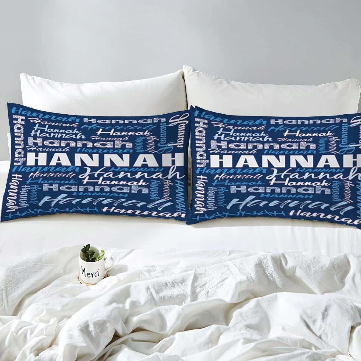 Overhead view of blue typography bedding spread across a contemporary bedroom bed