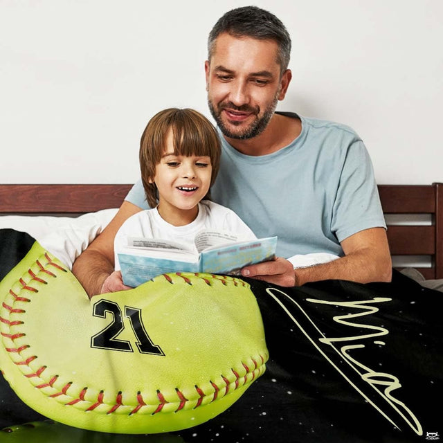 Softball throw blanket wrapped around father and child reading together in bed