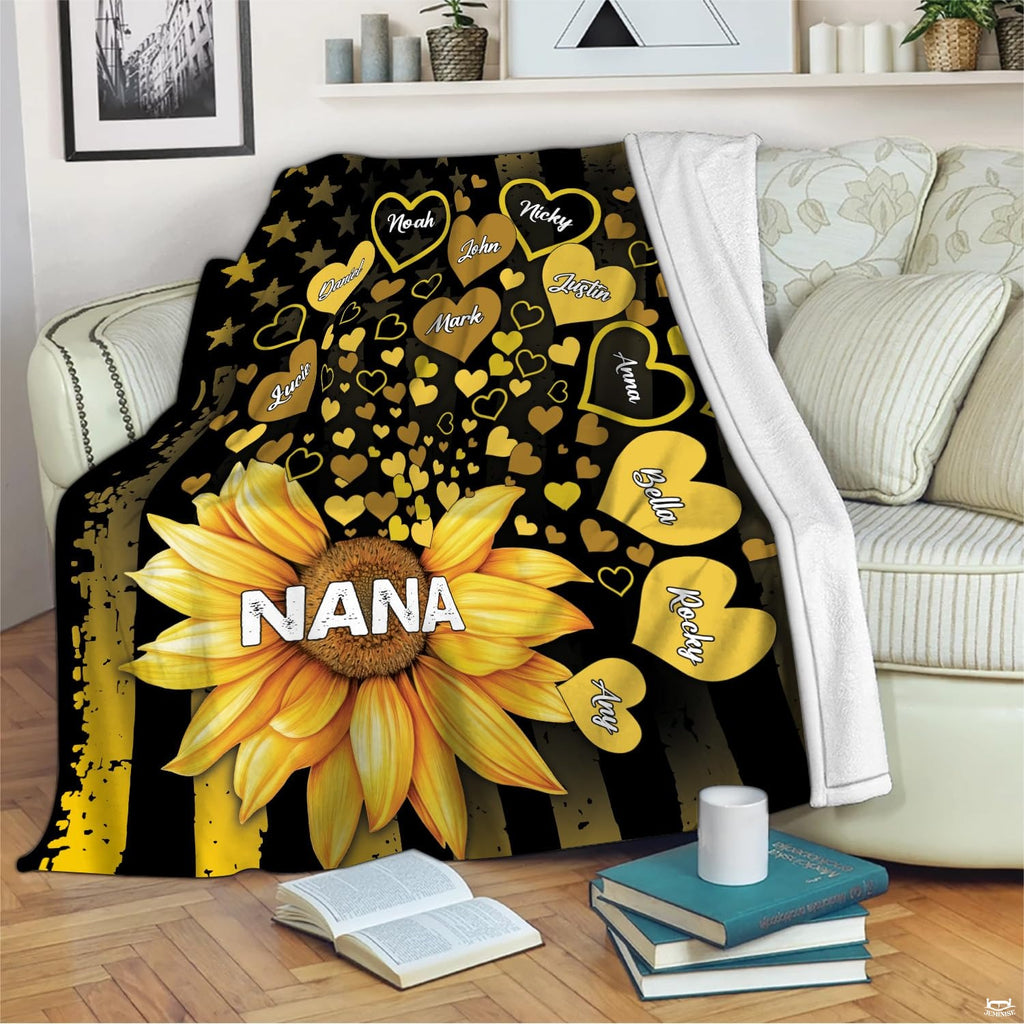 Living room display with the sunflower flag graphic draped over an armchair beside books.