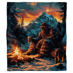Solitary Bigfoot enjoying beer by a winter campfire at sunset, view 7.