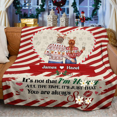 Holiday couple inside candy cane heart frame on diagonal peppermint stripes, view 3.
