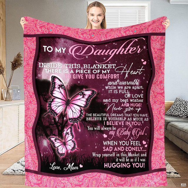 Bedroom lifestyle display showing the pink butterfly throw blanket styled over a bed.
