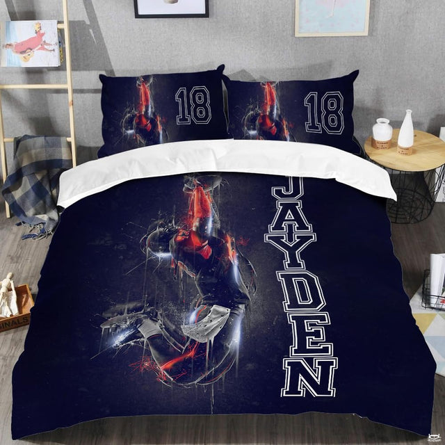 Close-up of collegiate block typography and jersey numbering on a sport bed cover with navy blue background.