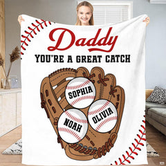 Full view of throw blanket displaying tan baseball mitt, three baseballs, and red corner lacing tracks.