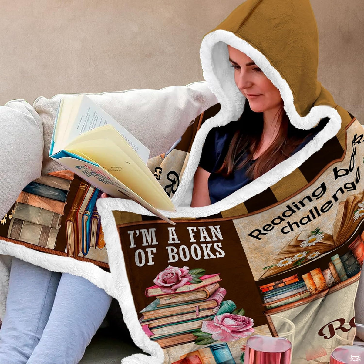 Book tree collage throw blanket layered neatly across a living room sofa